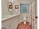 Bright bathroom featuring dual sinks, vanity, and natural light at 104 Whisper Trce, Peachtree City, GA 30269