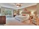 Spacious primary bedroom with large window, stylish furniture, and plush carpet at 104 Whisper Trce, Peachtree City, GA 30269