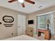 Bright bedroom with a chair, a mounted television, natural light, and a decorative mirror for a homey touch at 104 Whisper Trce, Peachtree City, GA 30269