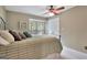 Inviting bedroom featuring a comfortable bed, a window with natural light, and closet for storage at 104 Whisper Trce, Peachtree City, GA 30269