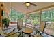 Relaxing covered patio features outdoor seating with view of landscaped backyard and water feature at 104 Whisper Trce, Peachtree City, GA 30269