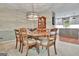 A well-lit dining area shows a round table with chairs and an open view to a gray and white kitchen at 104 Whisper Trce, Peachtree City, GA 30269