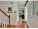 Bright foyer with hardwood floors, staircase, and a view into the living room provides a warm welcome at 104 Whisper Trce, Peachtree City, GA 30269