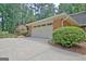 Attached garage with a large driveway and well-manicured landscaping at 104 Whisper Trce, Peachtree City, GA 30269
