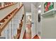 Hallway leading to a bedroom with staircase to the left, and full bathroom to the right at 104 Whisper Trce, Peachtree City, GA 30269