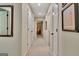 Hallway with neutral carpet and paint and white doors leading to various rooms at 104 Whisper Trce, Peachtree City, GA 30269