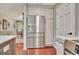 Kitchen with a stainless steel refrigerator and white cabinets, and the dining room can be seen at 104 Whisper Trce, Peachtree City, GA 30269