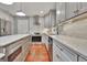 Spacious kitchen with stainless steel appliances, an island, and sleek white and gray cabinetry at 104 Whisper Trce, Peachtree City, GA 30269
