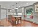 Beautiful kitchen featuring grey cabinets, stainless appliances, a window bench and wood floors at 104 Whisper Trce, Peachtree City, GA 30269