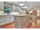Open kitchen featuring an island with bar seating and custom cabinetry at 104 Whisper Trce, Peachtree City, GA 30269