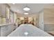 Open-concept kitchen with sleek white counters, pendant lights, and access to the living area at 104 Whisper Trce, Peachtree City, GA 30269