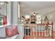 Open-concept living room featuring a fireplace, hardwood floors, and staircase with white railing at 104 Whisper Trce, Peachtree City, GA 30269