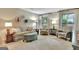 Cozy living room featuring comfortable sofa, accent chairs, and ample lighting at 104 Whisper Trce, Peachtree City, GA 30269