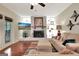 Cozy living room with fireplace, mantel, decor, ceiling fan, and hardwood floors at 104 Whisper Trce, Peachtree City, GA 30269