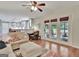 Bright and open living room with hardwood floors, fireplace, and access to the kitchen and patio at 104 Whisper Trce, Peachtree City, GA 30269