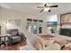 Bright living room features fireplace, ceiling fan, hardwood floors, and patio access at 104 Whisper Trce, Peachtree City, GA 30269