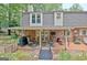 Inviting covered patio with comfortable seating, a grill, and access to the beautifully landscaped backyard at 104 Whisper Trce, Peachtree City, GA 30269