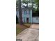 Charming two-story home with blue siding, dark shutters, and a paved driveway at 4981 Millstone Walk, Stone Mountain, GA 30088