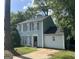 Charming two-story home with light blue siding, black shutters, and a well-manicured lawn at 4981 Millstone Walk, Stone Mountain, GA 30088