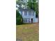 Charming two-story home with blue siding, dark shutters, and a well-maintained lawn at 4981 Millstone Walk, Stone Mountain, GA 30088