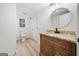 Stylish bathroom with granite counters, a modern mirror, and woodgrain floors at 1007 Fairway Seven, Villa Rica, GA 30180