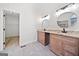 Bright bathroom with double vanity, stylish mirrors, granite countertop, and walk-in closet at 1007 Fairway Seven, Villa Rica, GA 30180