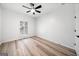 This bedroom features light wood-look floors and a modern ceiling fan at 1007 Fairway Seven, Villa Rica, GA 30180