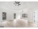 Bright primary bedroom featuring tray ceilings, large windows, and light wood floors at 1007 Fairway Seven, Villa Rica, GA 30180