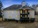Rear exterior of home with multi-level deck and balcony, set in a lush yard at 1007 Fairway Seven, Villa Rica, GA 30180