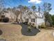 Brick home shows manicured lawn with lush landscaping and traditional architecture at 1007 Fairway Seven, Villa Rica, GA 30180