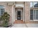 Charming brick home featuring a welcoming front door with sidelights and a decorative archway at 1007 Fairway Seven, Villa Rica, GA 30180
