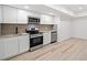 Modern kitchen with stainless steel appliances, granite countertops and woodgrain floors at 1007 Fairway Seven, Villa Rica, GA 30180