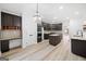 Spacious kitchen featuring dark cabinets, granite counters, and a center island at 1007 Fairway Seven, Villa Rica, GA 30180