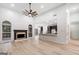 Inviting living space with large windows, an open layout, and a cozy fireplace at 1007 Fairway Seven, Villa Rica, GA 30180