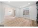 Open living room with natural light, light wood floors, and traditional molding at 1007 Fairway Seven, Villa Rica, GA 30180