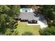 Aerial view of the property featuring a pool, gray roof, and expansive yard surrounded by trees at 125 Wendell Ct, Fayetteville, GA 30215