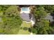 Aerial view of a private home nestled among trees, with a long driveway and a pool in the backyard at 125 Wendell Ct, Fayetteville, GA 30215