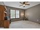 Comfortable bedroom with a ceiling fan and bright window with wood trim at 125 Wendell Ct, Fayetteville, GA 30215