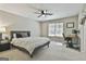 Comfortable bedroom with a ceiling fan, a large window, and a work desk at 125 Wendell Ct, Fayetteville, GA 30215