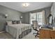 A comfortable bedroom with a ceiling fan, a bright window, and a study desk at 125 Wendell Ct, Fayetteville, GA 30215