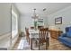 Bright dining room features wood floors, large window, and chandelier at 125 Wendell Ct, Fayetteville, GA 30215