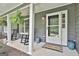 Close-up of a welcoming front porch with rocking chairs and decorative plants near the entrance at 125 Wendell Ct, Fayetteville, GA 30215