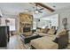 Cozy living room with stone fireplace, wood-look floors, and comfortable sectional couch at 125 Wendell Ct, Fayetteville, GA 30215