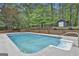 Refreshing in-ground pool is surrounded by a well-maintained yard and lush greenery, great for summertime enjoyment at 125 Wendell Ct, Fayetteville, GA 30215