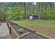 Landscaped backyard features a charming shed and lush greenery at 125 Wendell Ct, Fayetteville, GA 30215