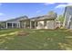 Lush backyard with green grass and an overview of the home's back exterior at 430 Silverbell Ct, Peachtree City, GA 30269