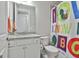 Colorful bathroom featuring a vanity with granite countertops and a fun shower curtain at 430 Silverbell Ct, Peachtree City, GA 30269