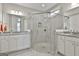 Modern bathroom featuring a frameless glass shower, dual sinks, and granite countertops at 430 Silverbell Ct, Peachtree City, GA 30269