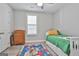 Cozy bedroom featuring natural light, wood-look floors and a decorative area rug at 430 Silverbell Ct, Peachtree City, GA 30269