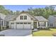 Charming single-story home with a three-car garage, tidy lawn, and manicured landscaping at 430 Silverbell Ct, Peachtree City, GA 30269